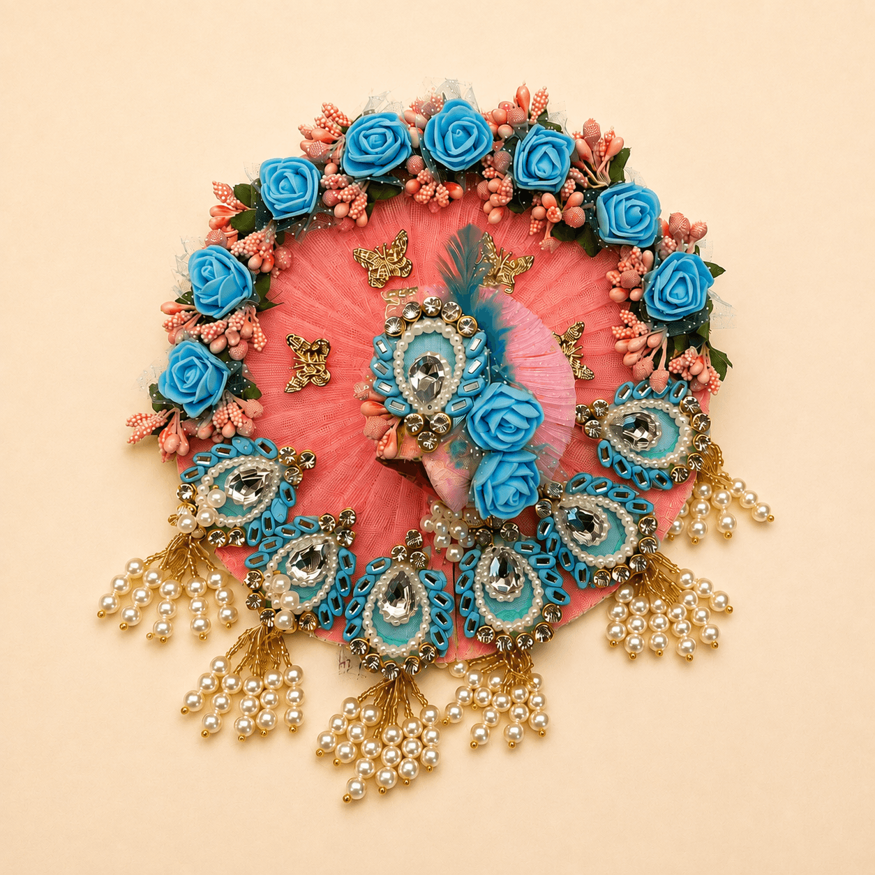Coral pleated net poshak crowned with blue roses and hung with pearl tassel latkan