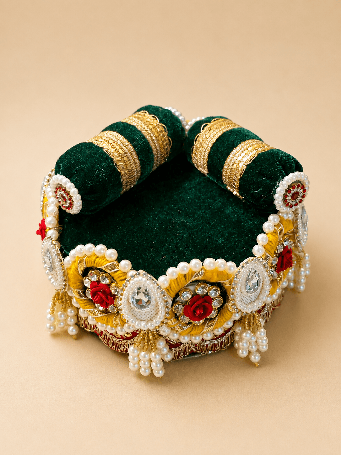 Bottle-green velvet gadi with a yellow resham, red rose and kundan border