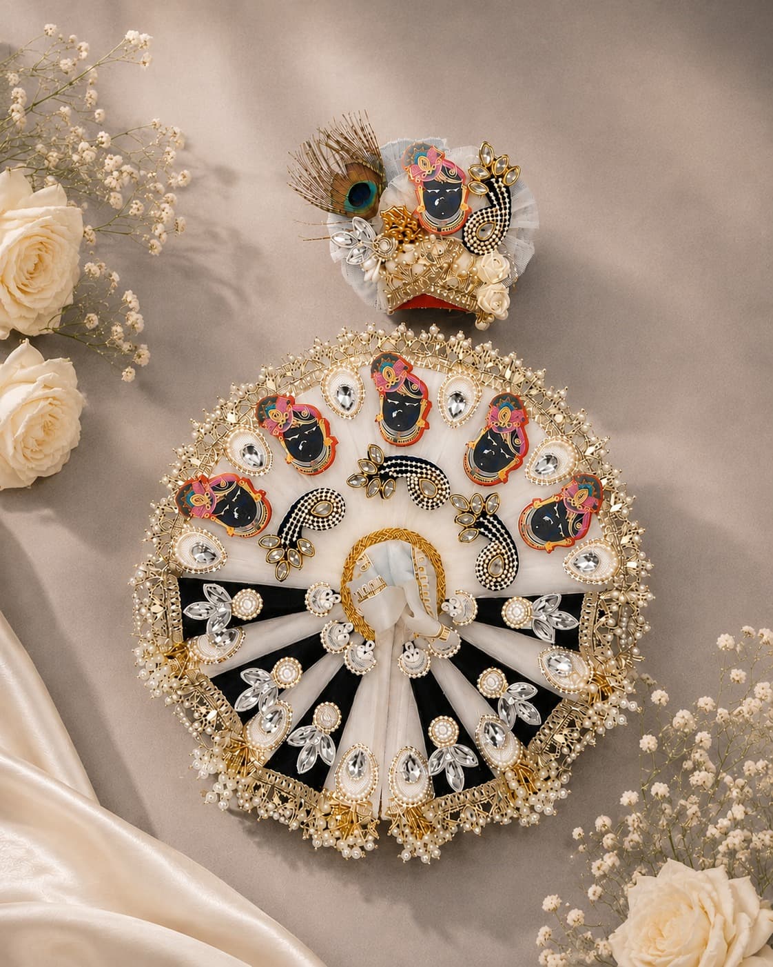 Ivory and black velvet poshak with painted Shrinathji patches, kundan stones and a pearl fringe